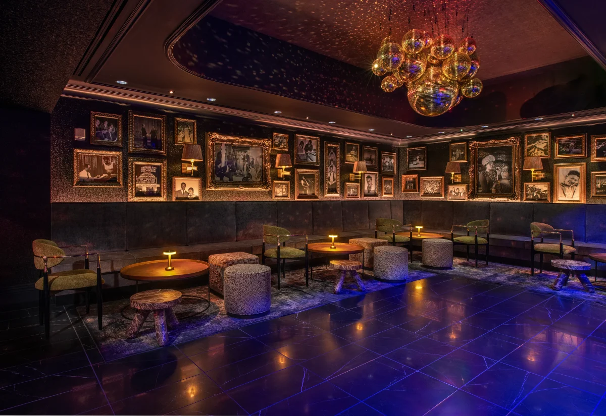 Ellas lounge with a wall of framed photographs and sculptural lighting