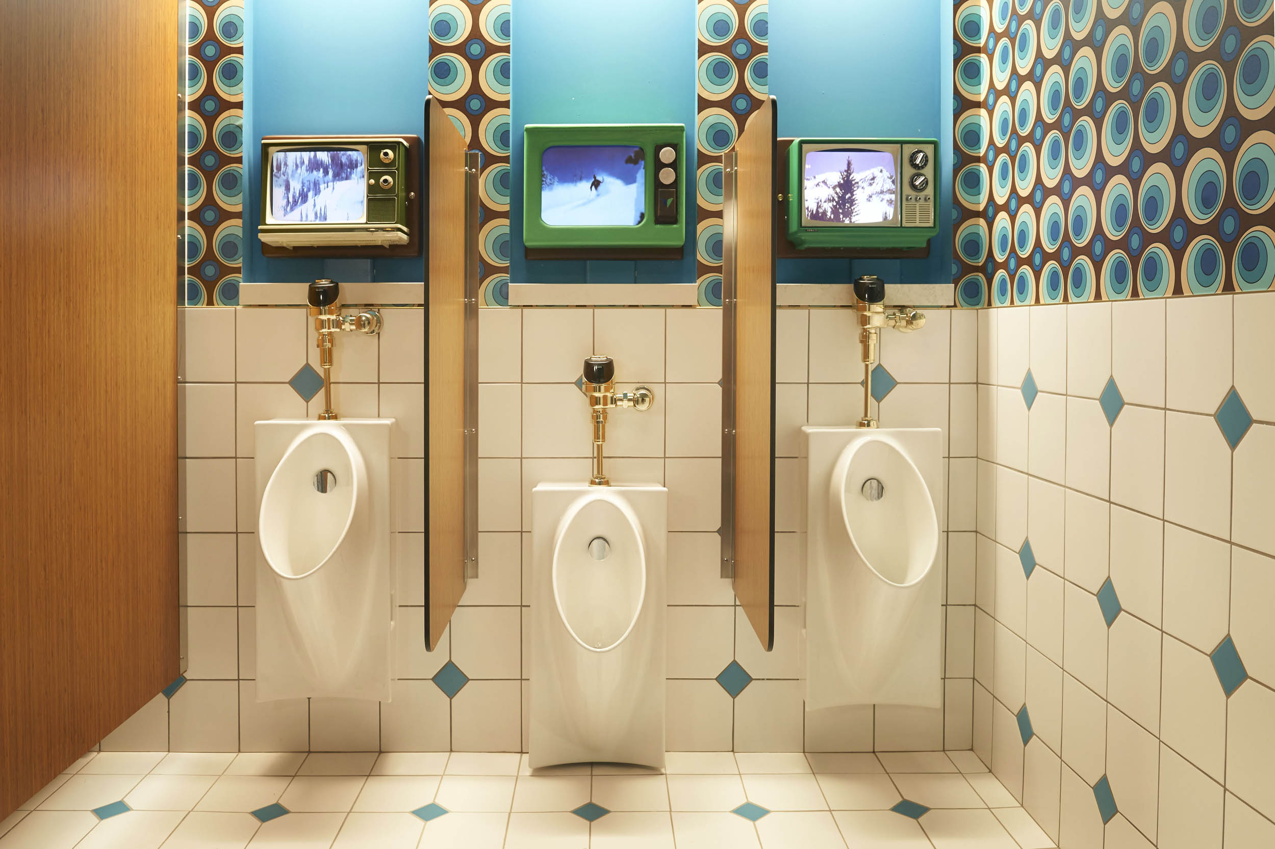 SeventyOne restroom with vintage televisions and patterned wallcovering